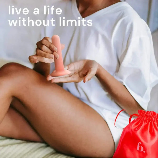 Woman holding a pink Bodyotics vaginal dilator with red carrying pouch nearby, promoting pelvic floor comfort and recovery